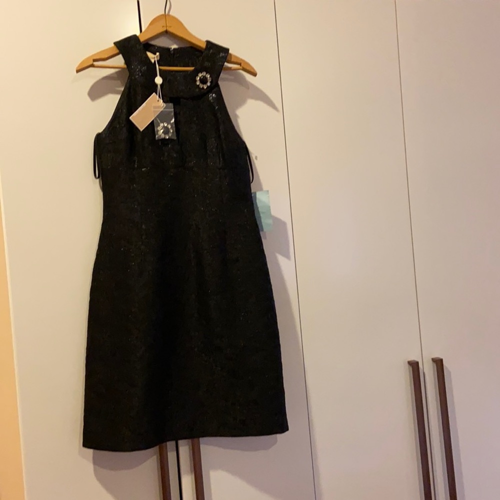 Michael Kors Black dress with flower broach.